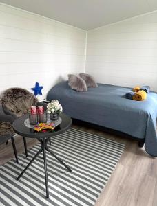 a bedroom with a bed and a table with a table at Baksas Luxury Campers in Selfoss