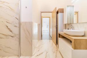 a bathroom with a sink and a mirror at Malpensa sweet home in Busto Arsizio +26 photos