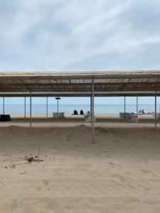a pavilion on a beach with the ocean in the background at Golden Bugas Sea View Золотий бугаз in Karolino-Buhaz