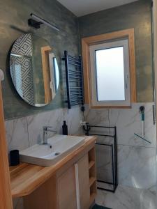 a bathroom with a sink and a mirror at LoftLove roztocze domek in Jędrzejówka +38 photos