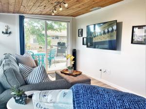 a living room with a couch and a tv at FUN! PoolLake near Disney Fast WiFi Pickleball in Clermont