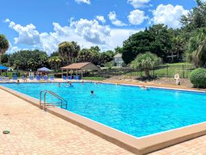 a swimming pool at a resort with people in it at FUN! PoolLake near Disney Fast WiFi Pickleball in Clermont