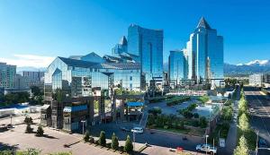 a city with tall buildings and a street with trees at Smart Lux 320 in Almaty
