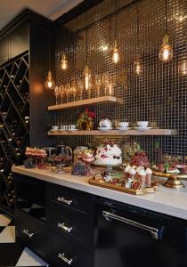 a room with a counter with a bunch of food at La Belle Maison in Tauranga