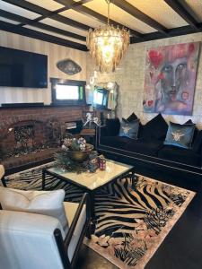a living room with a couch and a table at La Belle Maison in Tauranga