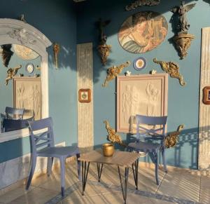 a dining room with blue walls and chairs and a table at Casa Roma Boutique Hotel in Bodrum City +84 photos