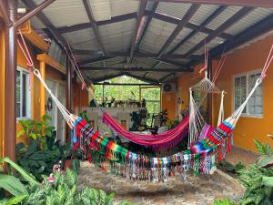 a hammock hanging from the porch of a house at Apartamento de July in Penonomé