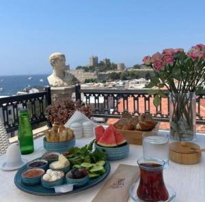 a table with plates of food on top of a balcony at Casa Roma Boutique Hotel in Bodrum City