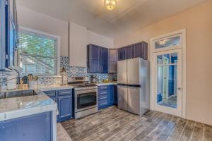 a kitchen with blue cabinets and a stainless steel refrigerator at Rosemont in Florence