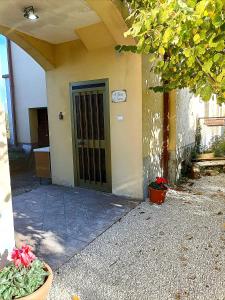 a door to a building with flowers in front of it at A casa di Irene in Le Marmore +109 photos