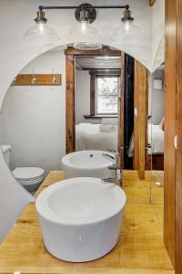 a bathroom with a white sink and a mirror at auxportesdesMilleIles in Laval +22 photos