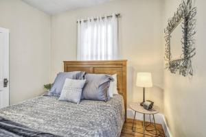 a bedroom with a bed with blue pillows at Brewster's Farm in Florence