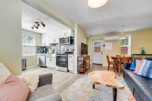 a living room with a couch and a table and a kitchen at Rosemont Cottage in Florence
