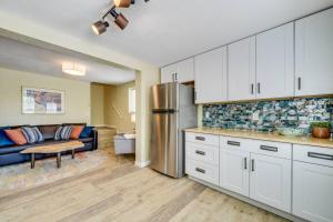 a kitchen with a refrigerator and a couch in a room at Rosemont Cottage in Florence