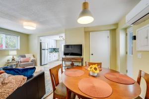 a living room with a table and chairs and a television at Rosemont Cottage in Florence