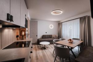 a living room with a table and a couch at Appartement Sport Steger in Saalbach-Hinterglemm +15 photos