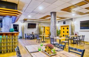 a restaurant with tables and chairs and a bar at Národní dům Podbořany in Podbořany