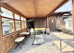 a patio with tables and chairs on a wooden deck at YOLKI HAUS moderne Apartments, nahe Wölfersheimer See in Wölfersheim