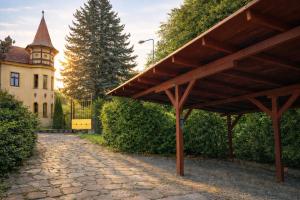 a pavilion in front of a building with a house at Villa Emausy in Luhačovice +35 photos