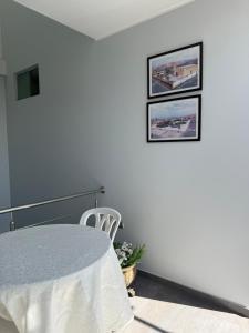 a white room with a table and two pictures on the wall at Hotel Luz de Luna in Atico