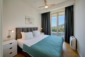 a bedroom with a large bed and a window at Skyline resort CG in Budva +262 photos
