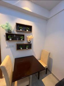 a dining room with a table and chairs and plants at Aawas studio in Noida