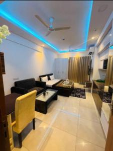 a living room with a couch and a table at Aawas studio in Noida