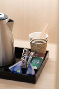 a tray with a coffee pot and a cup on a table at Polar Nook Hotel in Rovaniemi