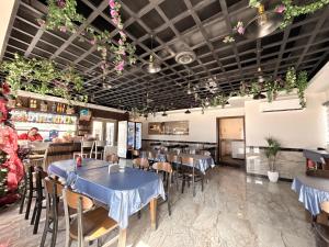a restaurant with tables and chairs and flowers on the ceilings at Hotel Los Diamantes in Rancho Los Limones
