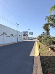 an empty road in front of a building at Hotel Los Diamantes in Rancho Los Limones