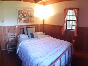 a bedroom with a large bed and a window at Coastal Cabin above the Clouds in Brookings