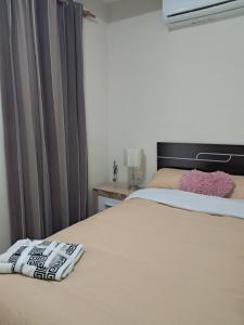 a bedroom with a bed with a black headboard at HC Home in Algeciras