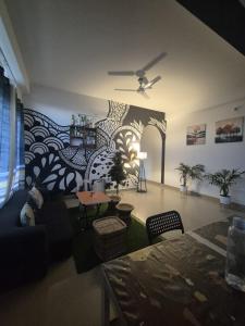 a living room with a large mural on the wall at Boho Rooms in Jorhat