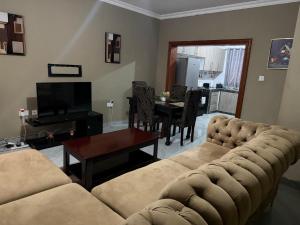 a living room with a couch and a table at Edmut Apartments in Lusaka