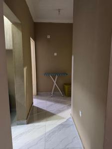 a room with a blue table in the corner at Edmut Apartments in Lusaka