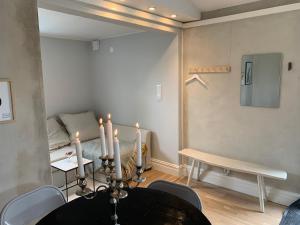 a room with a table and a bed with candles at Central guesthouse in Halmstad +6 photos