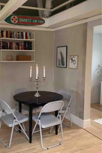 a dining room with a black table and chairs at Central guesthouse in Halmstad