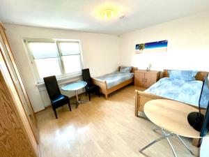 a bedroom with a bed and a table and chairs at Monteur Unterkunft 6 Betten in Karben +2 photos