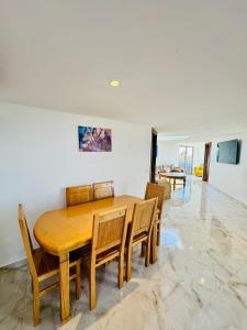 a dining room with a wooden table and chairs at بوابة الشمس 2 in Agadir