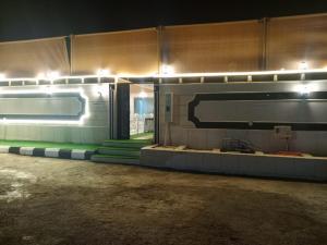 a room with a wall with lights on it at شاليه لارا in Rayyis