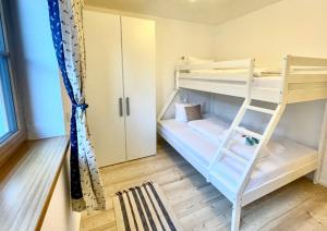 a bunk bed with a ladder in a room at Ferienwohnung 'Breitenstein' am Schliersee in Schliersee