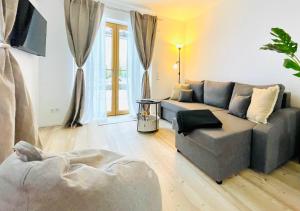 a living room with a couch and a table at Ferienwohnung 'Breitenstein' am Schliersee in Schliersee +7 photos