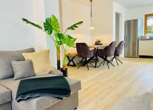 a living room with a couch and a table with chairs at Ferienwohnung 'Breitenstein' am Schliersee in Schliersee