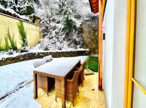 a table and chairs on a patio in the snow at Ferienwohnung 'Breitenstein' am Schliersee in Schliersee