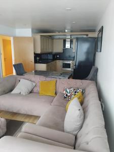 a living room with a couch with pillows on it at 2 Bedroom APARTMENT in Manchester