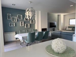 a living room with a table and chairs and a couch at SeaHorse House in Esposende