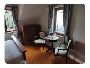 a bedroom with a bed and a table and chairs at Dairy Guesthouse in Cappamore