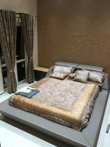 a large bed in a room with curtains at Gazalle Oasis in El Biar
