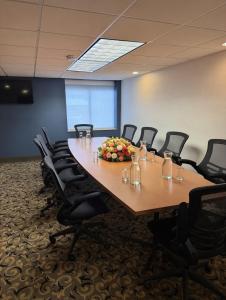 a conference room with a long table and chairs at Wingate by Wyndham Utica in Utica