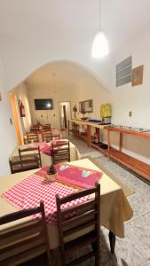 a dining room with tables and chairs in a room at Pousada A CASA DE IRENE in Aparecida +31 photos